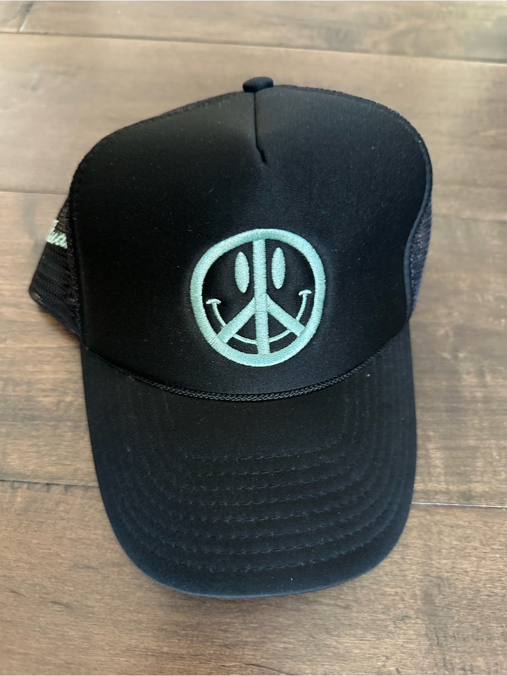Black Trucker Hat with Turquoise Smiley Peace Logo